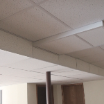 Drop ceiling covering ductwork and piping in basement