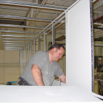 Installing ceiling tiles in a vertical drop for a suspended ceiling