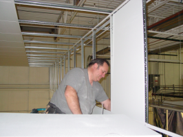 Installing ceiling tiles in a vertical drop for a suspended ceiling